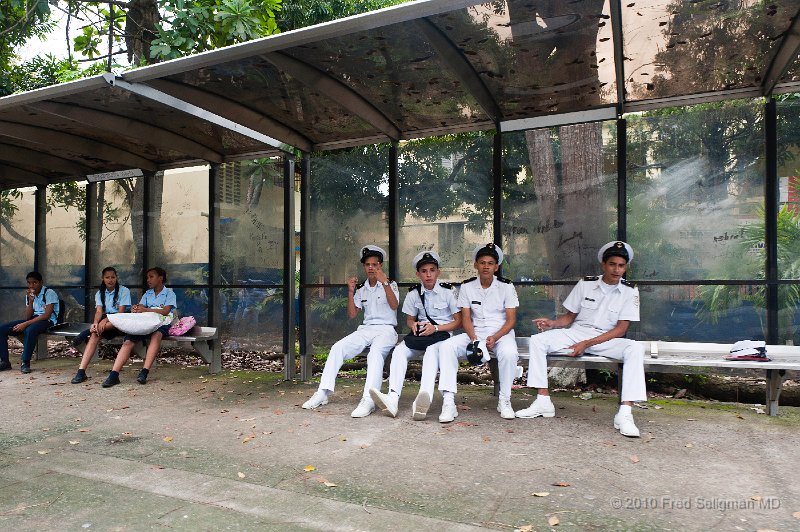 20101202_111630 D3.jpg - Students waiting at bus stop.  These white military-style uniforms seemed like a popular school uniform for boys